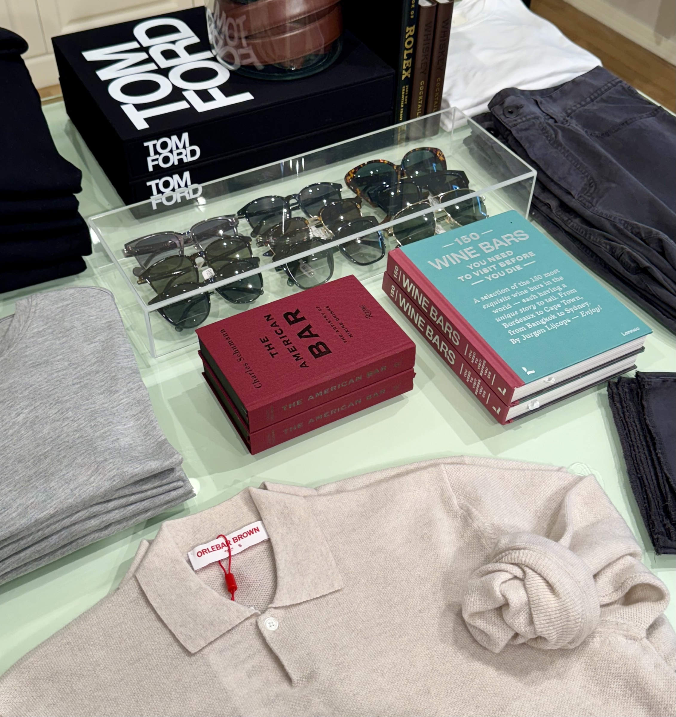 Casa Del Mar display with sunglasses, apparel, and color-coordinated fashion and travel books
