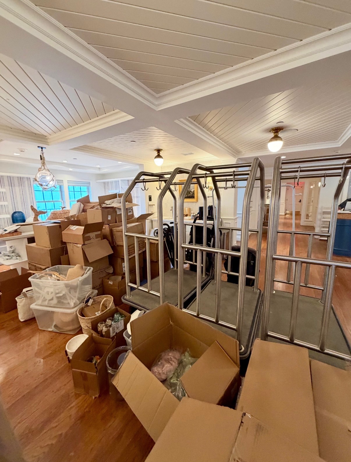 Nantucket consulting property before setup, with incoming boxes, bins, and empty display fixtures